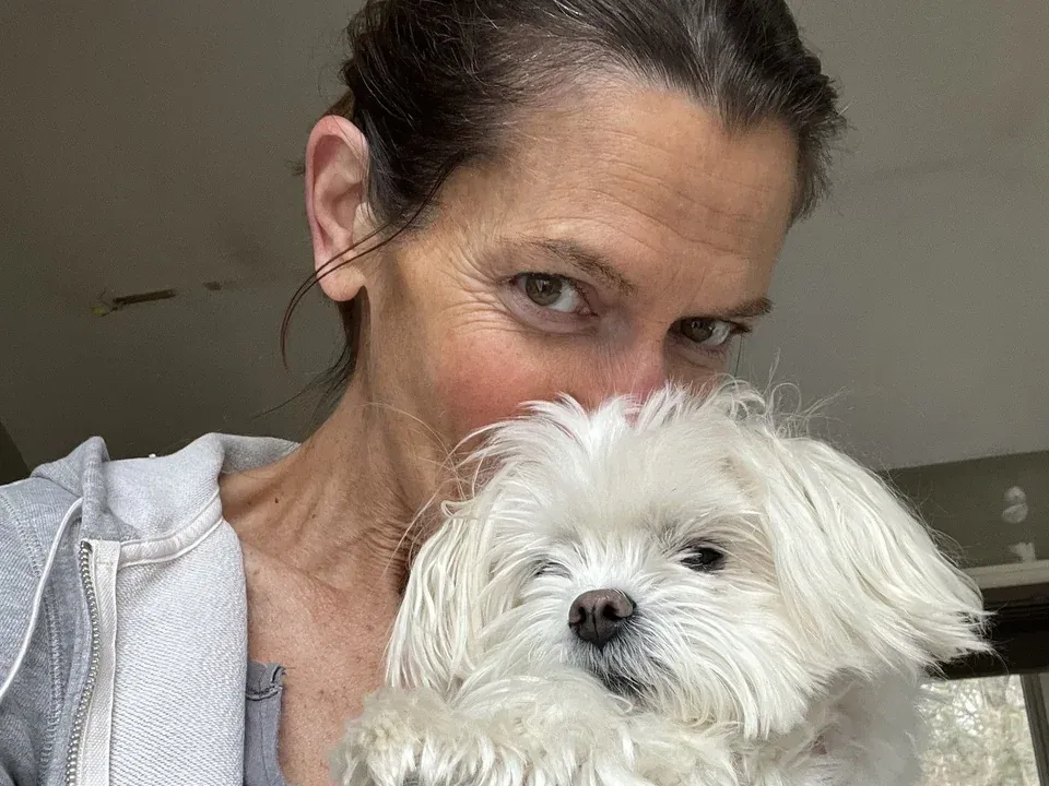 Dr. Deborah Burke holding a small white Maltese